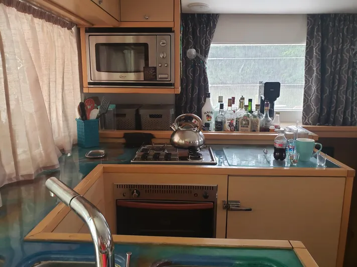 Bear, De Yacht Photos Pics Kitchen interior of 2011 Lagoon 450 yacht with appliances and countertop items.