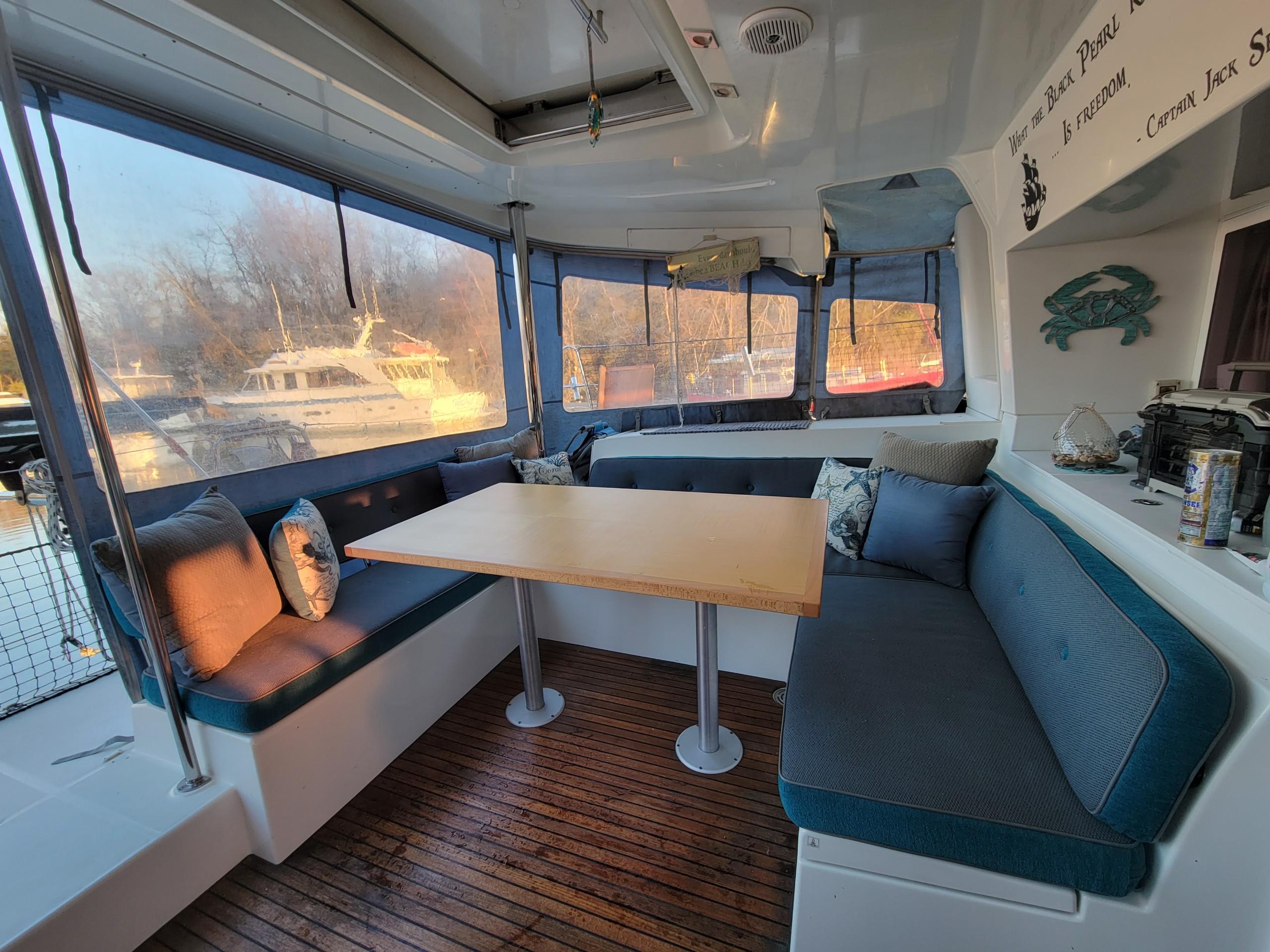 Spacious interior of 2011 Lagoon 450 catamaran with cozy seating and wooden flooring.