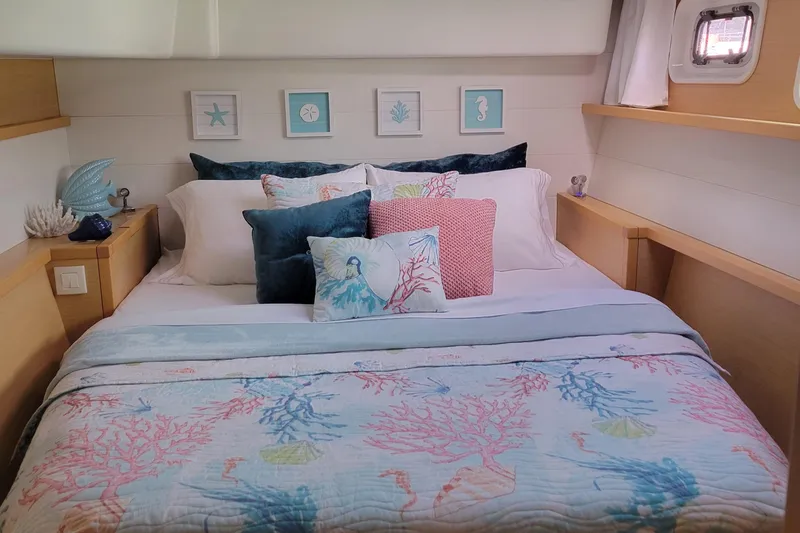 Bear, De Yacht Photos Pics Cozy bedroom in 2011 Lagoon 450 yacht with nautical-themed decor and colorful bedding.