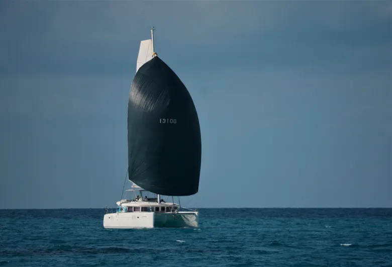 Bear, De Yacht Photos Pics Sailing catamaran Lagoon 450, 2011 model, cruising on open sea with large sail.