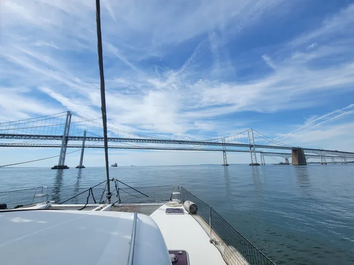 Bear, De Yacht Photos Pics Sailing under a bridge on a 2011 Lagoon 450 catamaran, clear skies above.