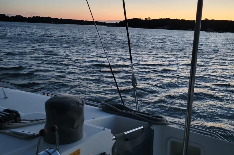 Bear, De Yacht Photos Pics Lagoon 450 catamaran sailing at sunset on calm waters, 2011 model.