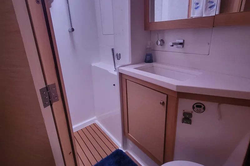 Bear, De Yacht Photos Pics Bathroom interior of 2011 Lagoon 450 yacht with wooden accents and modern fixtures.