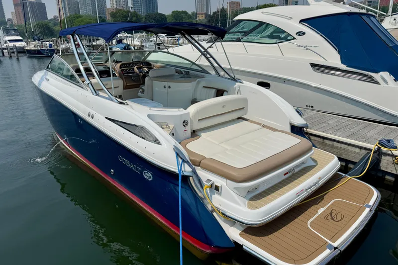  Yacht Photos Pics 2012 Cobalt 323 boat docked at marina, featuring sleek design and spacious seating.