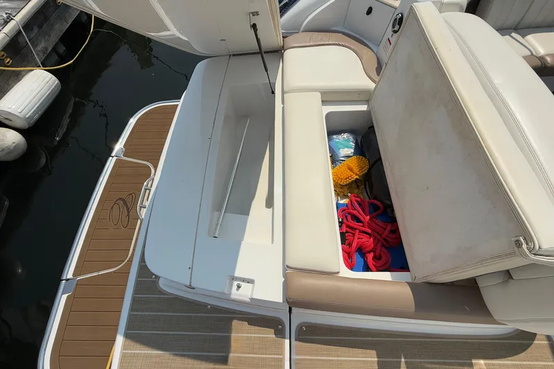  Yacht Photos Pics 2012 Cobalt 323 boat with open storage compartment, revealing ropes and cleaning supplies.