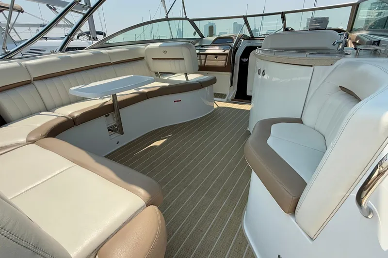  Yacht Photos Pics Luxurious interior of a 2012 Cobalt 323 boat with plush seating and a small table.