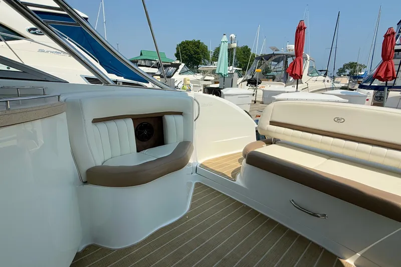  Yacht Photos Pics Luxurious 2012 Cobalt 323 boat interior with white seating and wood accents at a marina.