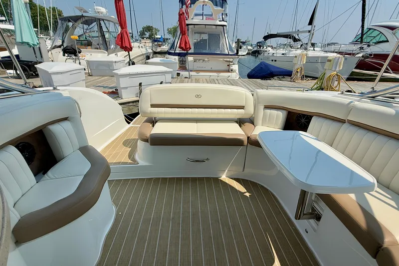  Yacht Photos Pics Luxurious 2012 Cobalt 323 boat interior with plush seating and table at marina.
