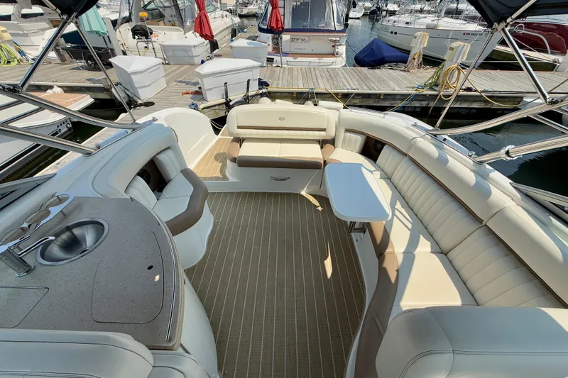  Yacht Photos Pics Luxurious 2012 Cobalt 323 boat interior with seating, table, and sink at marina.