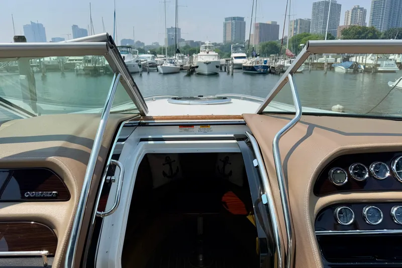  Yacht Photos Pics Interior view of a 2012 Cobalt 323 boat docked at a marina with city skyline.