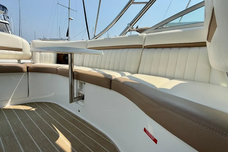  Yacht Photos Pics 2012 Cobalt 323 boat interior with beige and white seating, sleek table, and modern design.