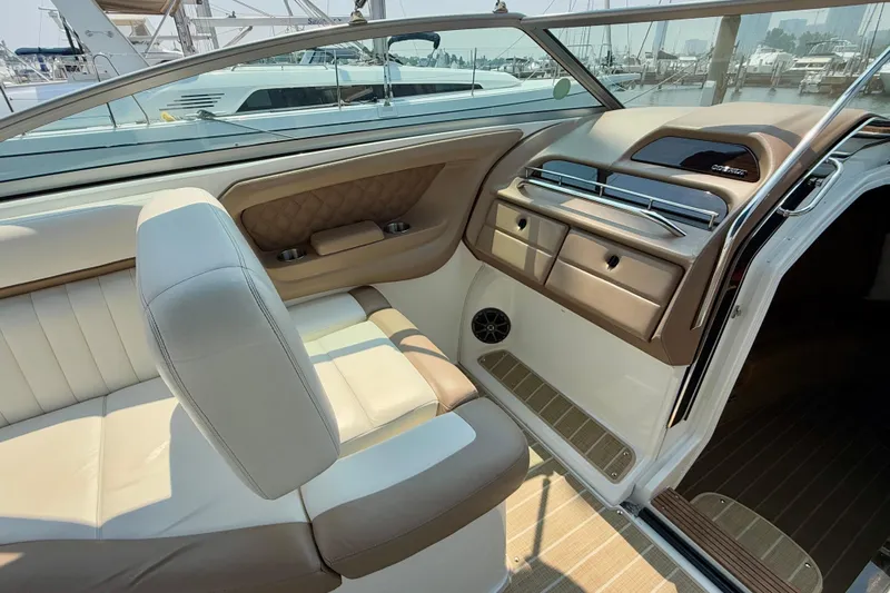  Yacht Photos Pics Interior of a 2012 Cobalt 323 boat, featuring beige and white seating with a sleek dashboard.