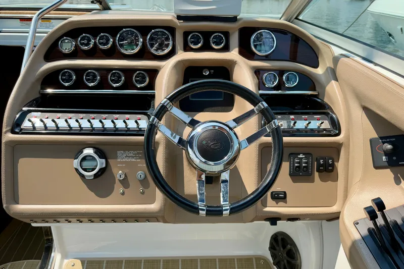  Yacht Photos Pics Steering console of a 2012 Cobalt 323 boat with gauges and controls.