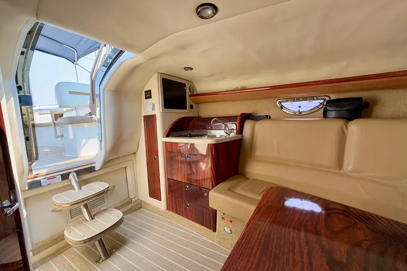  Yacht Photos Pics Luxurious interior of 2012 Cobalt 323 boat with seating and kitchenette.