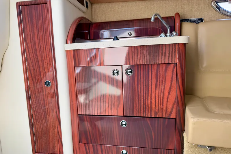  Yacht Photos Pics Luxurious wooden cabinetry with sink in 2012 Cobalt 323 boat interior.