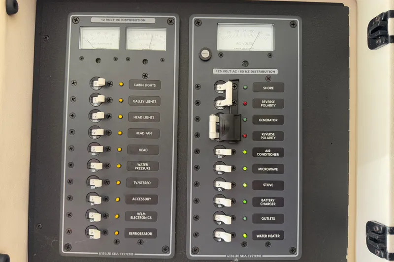  Yacht Photos Pics Electrical panel of a 2012 Cobalt 323 boat with labeled switches and meters.