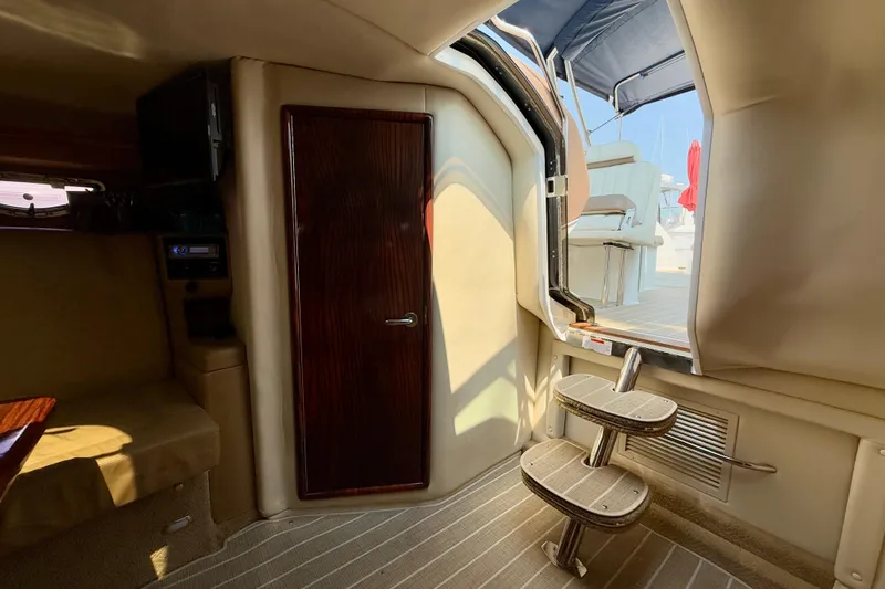  Yacht Photos Pics Interior of a 2012 Cobalt 323 boat, featuring a cabin door and steps to the deck.