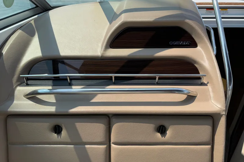  Yacht Photos Pics Interior of a 2012 Cobalt 323 boat, featuring beige leather and wood accents.