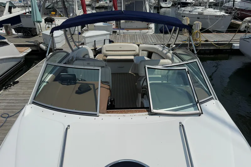 Yacht Photos Pics 2012 Cobalt 323 boat docked at marina, featuring open cockpit and blue canopy.