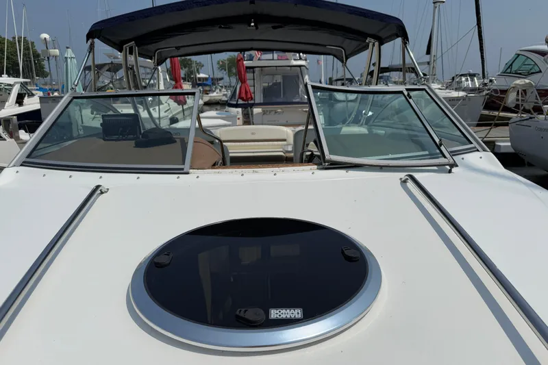  Yacht Photos Pics 2012 Cobalt 323 boat docked at marina, featuring windshield and open cockpit.