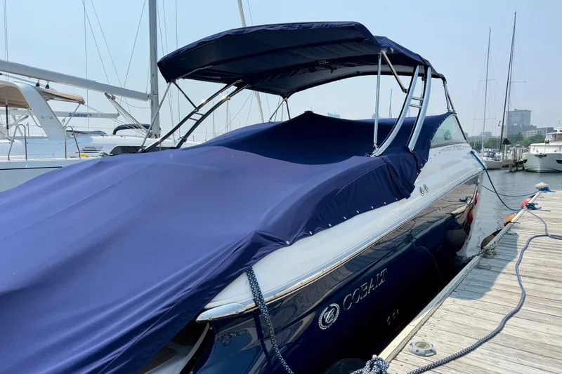  Yacht Photos Pics 2012 Cobalt 323 boat with blue cover docked at marina.