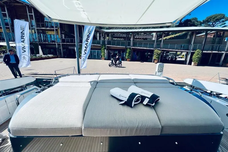  Yacht Photos Pics 2023 Azimut S7 yacht with sunbed and towels, displayed at a marina event.