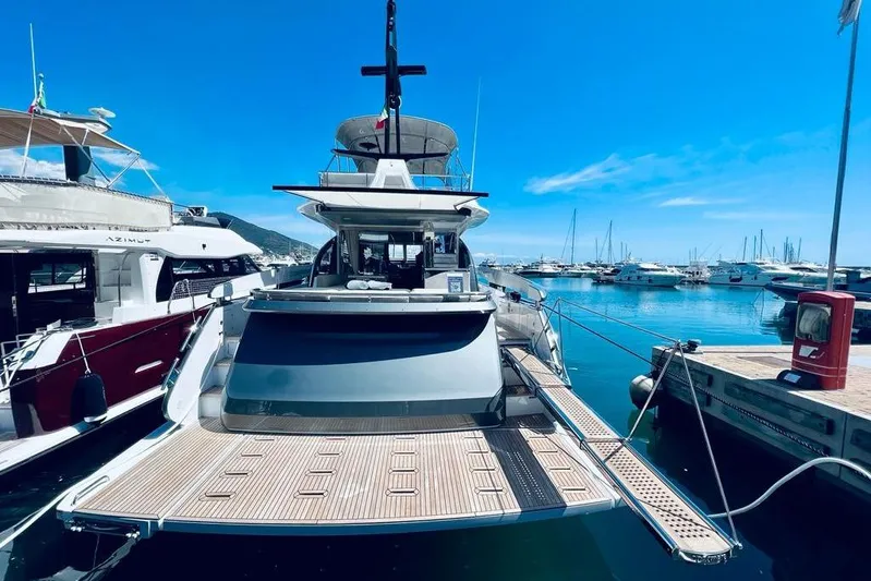  Yacht Photos Pics 2023 Azimut S7 yacht docked at a marina under a clear blue sky.