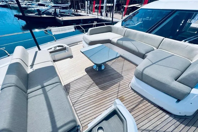 Yacht Photos Pics Luxurious 2023 Azimut S7 yacht deck with elegant seating and table, docked at marina.