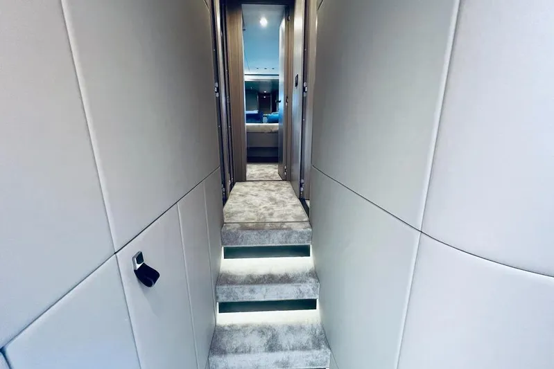  Yacht Photos Pics Luxurious interior hallway of 2023 Azimut S7 yacht with carpeted steps and modern design.