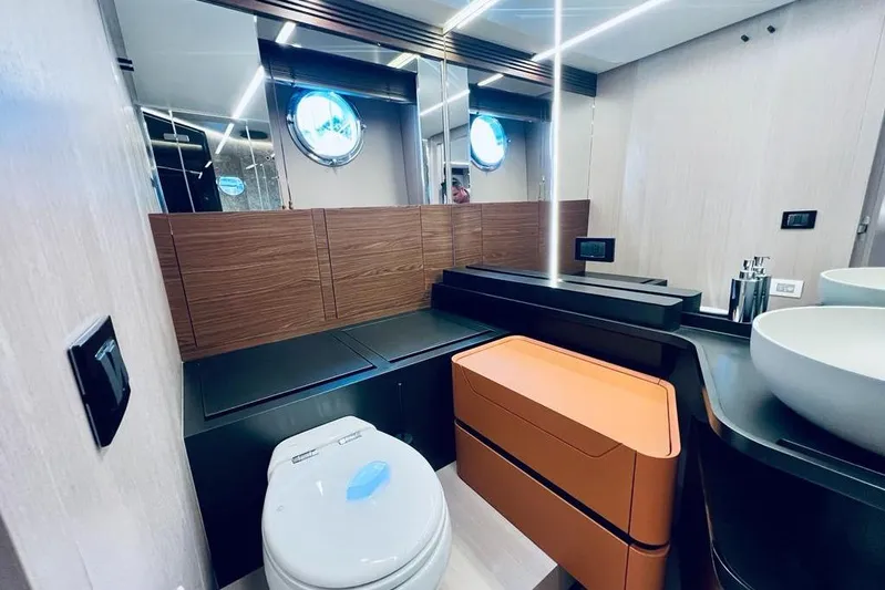  Yacht Photos Pics Luxurious bathroom interior of 2023 Azimut S7 yacht with modern fixtures and porthole window.