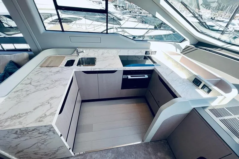  Yacht Photos Pics Luxurious 2023 Azimut S7 yacht kitchen with marble countertops and modern appliances.