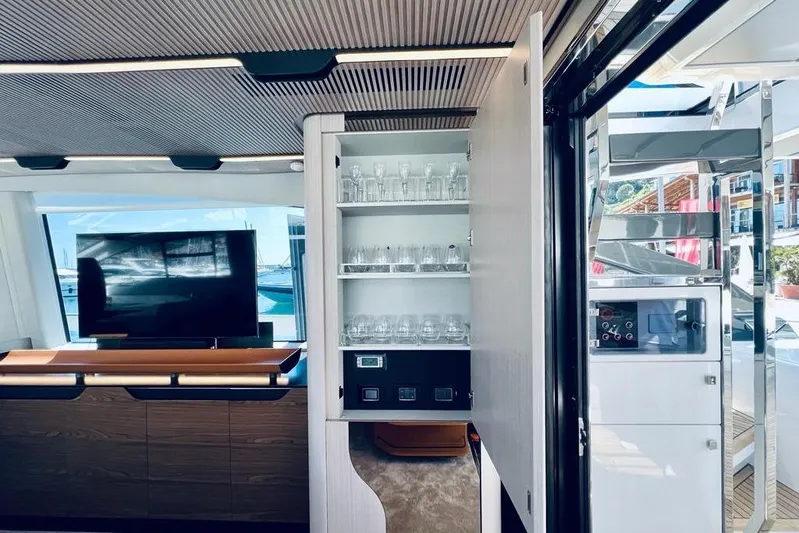  Yacht Photos Pics Luxurious interior of 2023 Azimut S7 yacht featuring modern cabinetry and glassware storage.