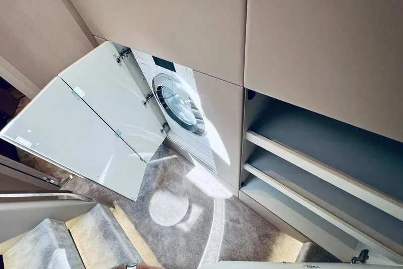 Yacht Photos Pics Laundry area with washing machine in 2023 Azimut S7 yacht interior.