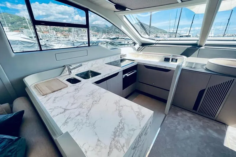  Yacht Photos Pics Luxurious 2023 Azimut S7 yacht kitchen with marble countertops and modern appliances.