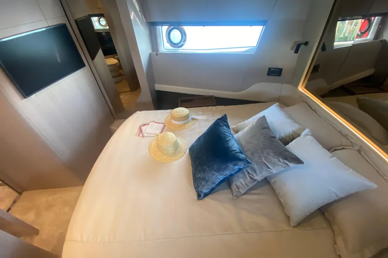  Yacht Photos Pics Luxurious bedroom interior of 2023 Azimut S7 yacht with elegant decor and natural light.