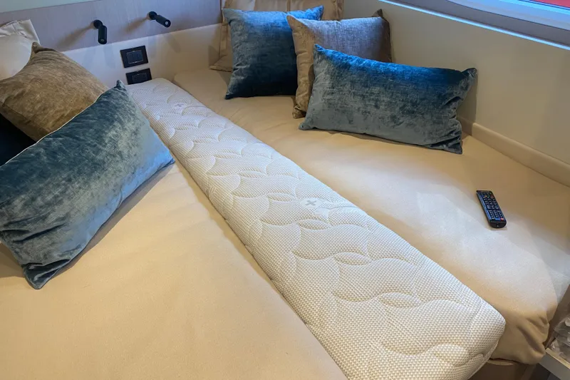  Yacht Photos Pics Luxurious Azimut S7 2023 yacht interior with plush bedding and remote control.