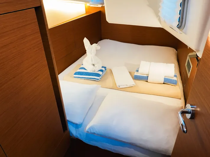 Easy Skanking Yacht Photos Pics Cozy cabin interior of 2024 Jeanneau Sun Odyssey 410 with neatly arranged towels.
