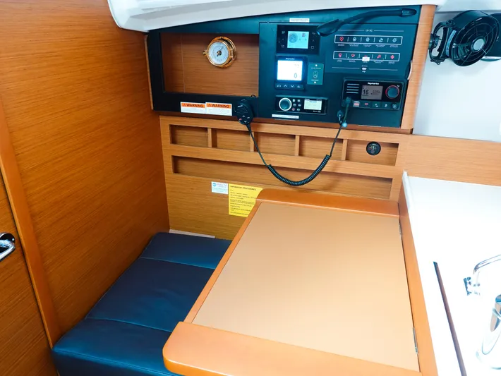 Easy Skanking Yacht Photos Pics Navigation station of 2024 Jeanneau Sun Odyssey 410 yacht with control panel and seating.