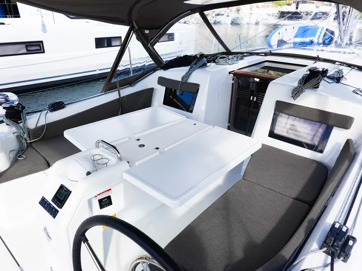 Easy Skanking Yacht Photos Pics 2024 Jeanneau Sun Odyssey 410 cockpit with seating, table, and navigation equipment.