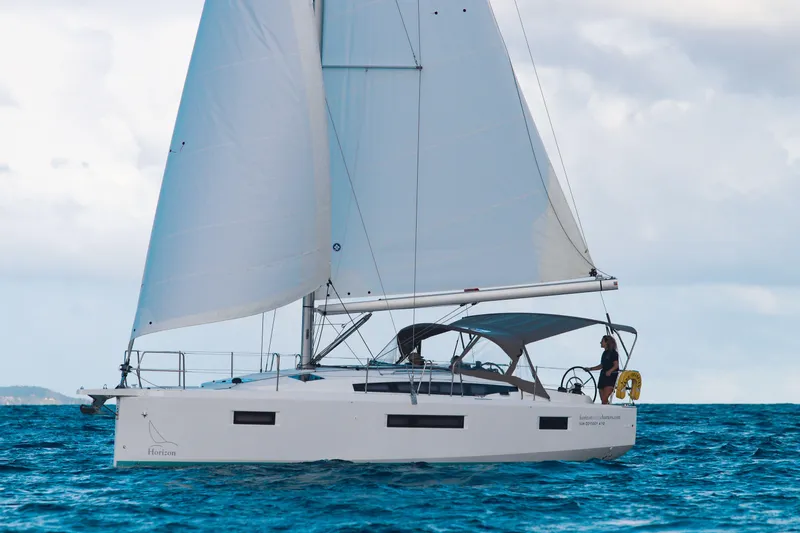 Easy Skanking Yacht Photos Pics 2024 Jeanneau Sun Odyssey 410 sailing on open water, side view.