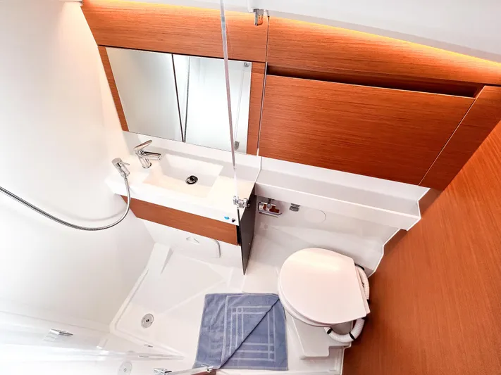 Easy Skanking Yacht Photos Pics 2024 Jeanneau Sun Odyssey 410 bathroom with modern fixtures and wooden accents.