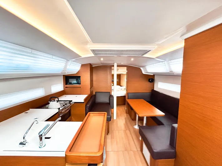 Easy Skanking Yacht Photos Pics 2024 Jeanneau Sun Odyssey 410 interior with modern kitchen and cozy seating area.