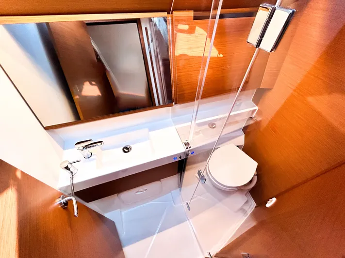 Easy Skanking Yacht Photos Pics 2024 Jeanneau Sun Odyssey 410 bathroom with modern fixtures and wooden accents.