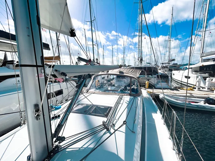 Easy Skanking Yacht Photos Pics 2024 Jeanneau Sun Odyssey 410 sailboat docked in a marina under a clear blue sky.
