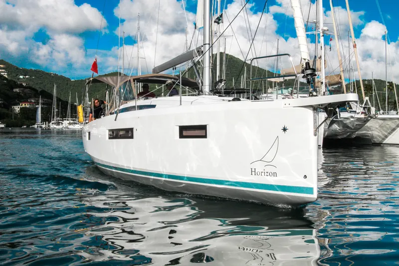 Easy Skanking Yacht Photos Pics 2024 Jeanneau Sun Odyssey 410 sailboat docked in a scenic marina.