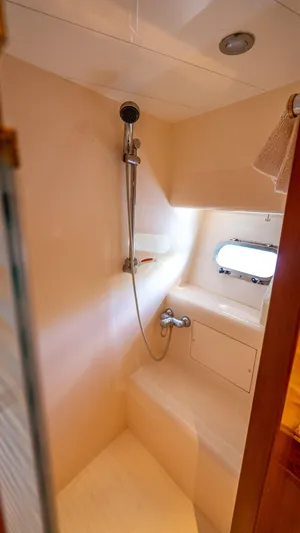  Yacht Photos Pics Shower area in 2003 Horizon 62 Sport Yacht with window and modern fixtures.