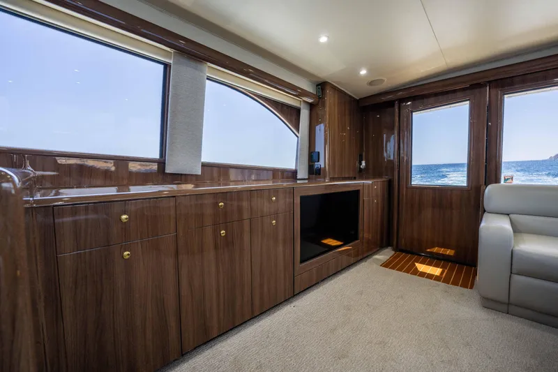Santana Yacht Photos Pics Luxurious interior of 2003 Viking 65 Convertible yacht with wood cabinetry and ocean view.