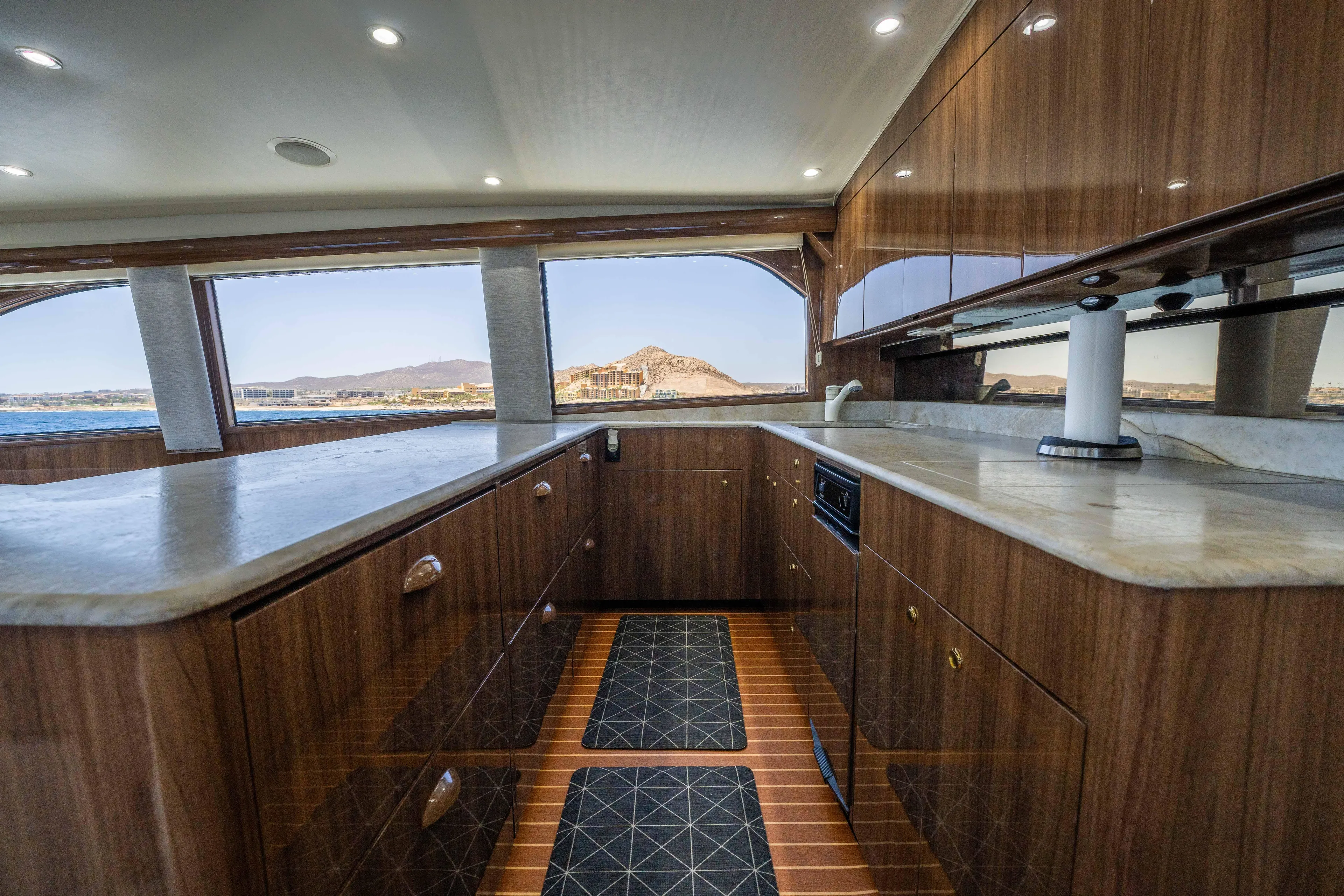 Santana Yacht Photos Pics Luxurious kitchen interior of 2003 Viking 65 Convertible yacht with wood cabinetry and ocean view.
