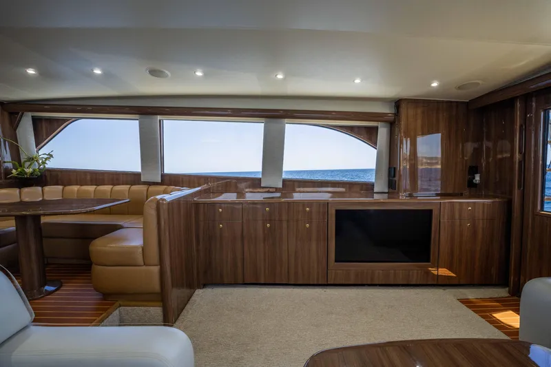 Santana Yacht Photos Pics Luxurious interior of a 2003 Viking 65 Convertible yacht with wood finishes and ocean view.