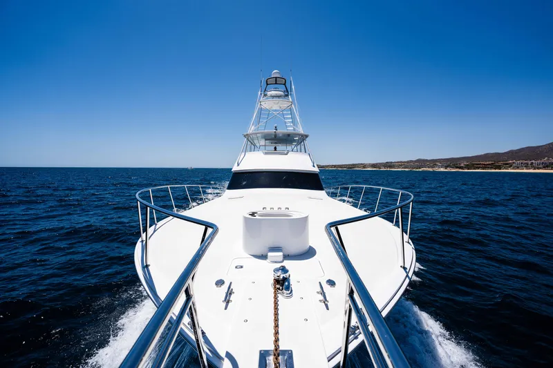 Santana Yacht Photos Pics 2003 Viking 65 Convertible yacht cruising on open sea under clear blue sky.